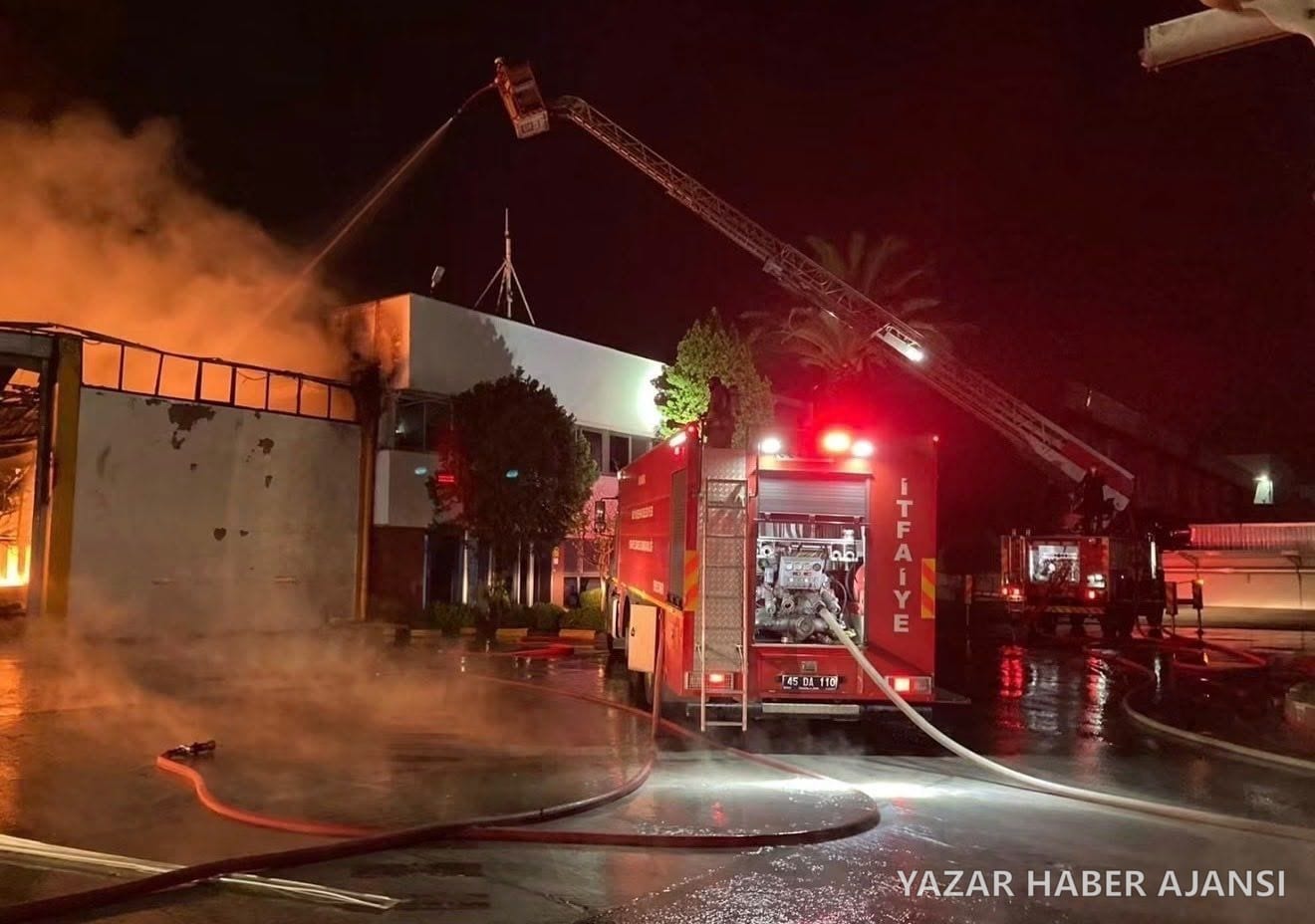 Manisa OSB'deki akü fabrikasında çıkan yangına itfaiye ekipleri merdivenli araçla müdahale ediyor (Fotoğraf: Manisa Büyükşehir Belediyesi)